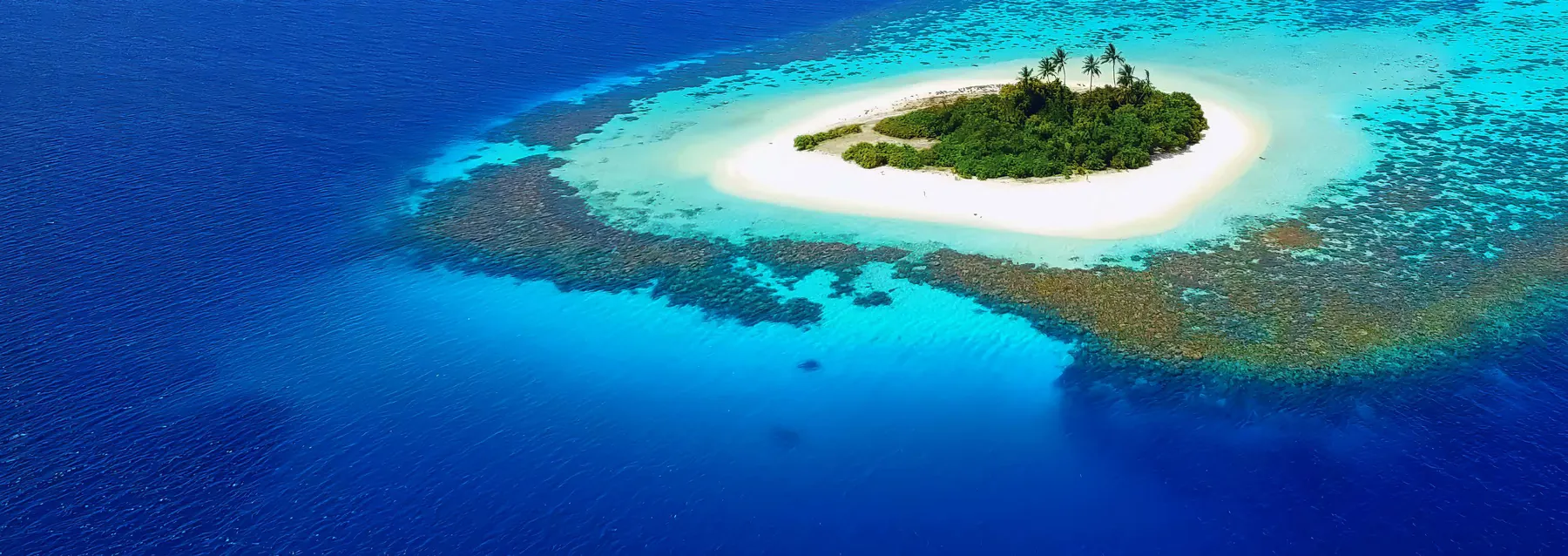 The Maldives atoll, a ring of reef and white sand in the Indian Ocean